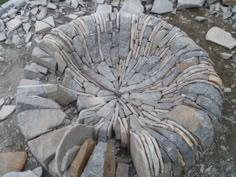 a stone fire pit surrounded by rocks and gravel