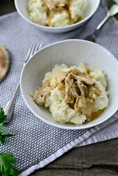 two white bowls filled with mashed potatoes and meat