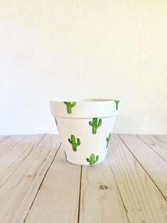 a cactus planter sitting on top of a wooden table