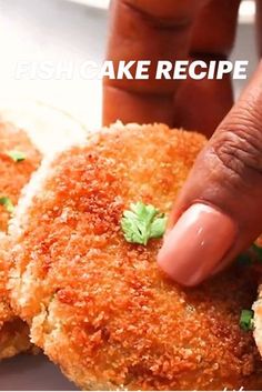 a person is touching some food on a plate with the words fish cake recipe above it