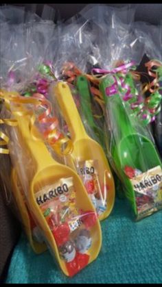 plastic utensils are lined up on the back seat of a car with candy in them