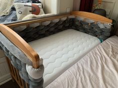 a baby crib that has been made into a bed