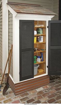 an outdoor storage shed with black shutters on the door and shelves full of cleaning supplies