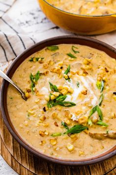 a bowl of soup with corn on the side