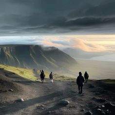 three people walking up a hill with dark clouds in the sky over them and mountains behind them