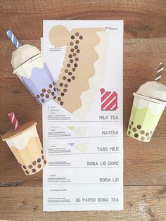 paper cups with straws on top of them next to a menu for a drink