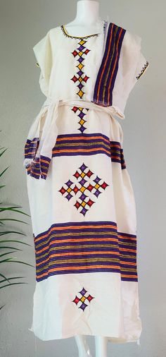 Free size Ethiopian Traditional Clothes. This a beautiful handmade Ethiopian dress with a unique design and style. Beautiful and comfortable White Folk Dress With Weaving Work, Traditional White Handwoven Dress, White Habesha Kemis With Woven Motifs For Traditional Ceremonies, White Folk Kaftan With Traditional Patterns, White Folk Habesha Kemis For Traditional Ceremonies, Folk Style White Habesha Kemis For Festival, White Habesha Kemis With Traditional Patterns For Festival, Bohemian White Habesha Kemis For Traditional Ceremonies, White Bohemian Habesha Kemis For Traditional Ceremonies