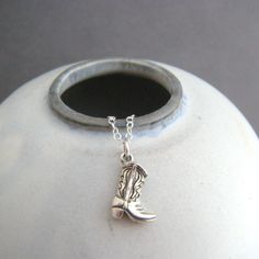 tiny sterling silver cowboy boot necklace, 1/2" - Small slanted solid sterling silver cowboy/cowgirl boot charm, 3/8" (10 mm) across, 1/2" (13 mm) down. - Necklace is 1.5 mm cable chain, length customizable at drop down menu. Lobster clasp and locking circle jump rings, all sterling silver. - Boot hangs at a slant (see pictures). - Boot details are oxidized (blackened) to bring out detail. - Looks the same on front and back, tiny 925 mark on bottom of boot.  - Comes wrapped in a cute gift tin, a Cowgirl Core, Cowboy Boot Necklace, Country Cowgirl, Sterling Silver Cleaner, Horse Jewelry, Top Rings, Coastal Cowgirl, Tin Gifts, Jewelry Model