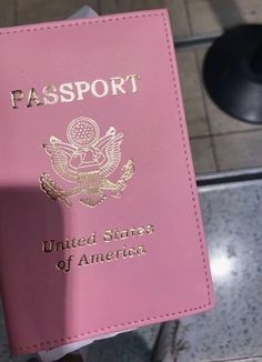 a pink passport sitting on top of a counter