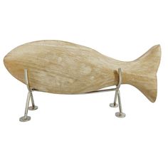 a wooden fish sculpture sitting on top of a metal stand