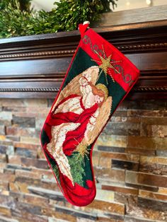 a christmas stocking hanging on a fireplace mantel in front of a brick wall