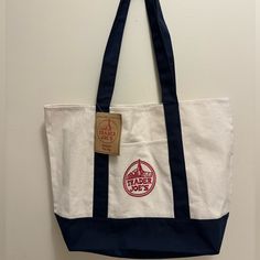 Trader Joe’s Tote Bag Nwt Embroidered Beige Canvas Bag With Embroidered Logo For Everyday Use, Everyday Beige Canvas Bag With Embroidered Logo, Casual Blue Shoulder Bag With Embroidered Logo, Everyday Blue Bag With Embroidered Logo, Blue Shoulder Bag With Embroidered Logo For Travel, Trader Joes Bag Aesthetic, White Canvas Bags With Embroidered Logo, White Canvas Shoulder Bag With Embroidered Logo, Trader Joes Tote Bags