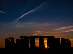 the sun is setting over stonehenge in england