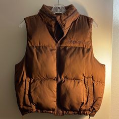 Brand New. Chocolate Brown Quilted Puffer Vest Mock Neck And Full Zip Closure Signature Pantone Branded Logo On Chest Lower Pockets Hidden Hood In Collar Brown Puffer Vest Outfit, Pantone Brown, Brown Puffer Vest, Brown Puffer Jacket, Puffer Vest Outfit, Brown Puffer, Hidden Hood, Quilted Puffer Vest, Vest Outfits