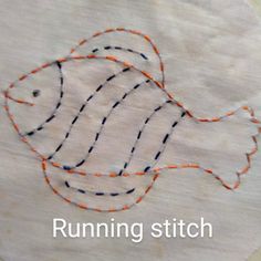 a close up of a fish on a piece of cloth with the words running stitch