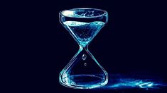 an hourglass with water running through it on a black background and blue light coming from the bottom