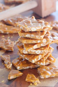 a stack of peanut butter pretzels sitting on top of a wooden cutting board