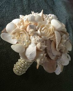 a bridal bouquet with seashells and pearls