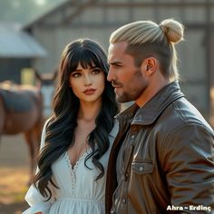 a man and woman standing next to each other in front of a brown horse barn