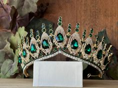 Beautiful, sparkles, GOOD QUALITY Tiara with big Emerald Green stones, with Crystal Rhinestone set on gold Tiara. Perfect for Prom, Birthday, Sweet 16, Quinceanera, Anniversary, Wedding, or for any other special occasion. Or just to be THE QUEEN. THE COLORS ON THE TIARA: Gold the tiara frame, Emerald Green and Crystal clear Rhinestone THE SIZE  2.50" tall on the front.  2.25" tall on the sides. GIFT BOX IT'S NOT INCLUDED! This item it will send on STANDARD FIRST CLASS MAIL (2 to 5 business days) Emerald Green Quinceanera, Birthday Tiaras, Green Tiara, Quince Pictures, Green Quinceanera, Birthday Sweet 16, Quinceanera Tiaras, Tiara Gold, Emerald Green Stone