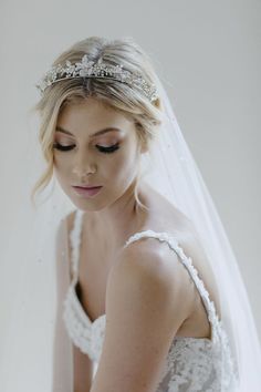 a woman in a wedding dress with a veil on her head