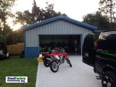 two motorcycles are parked in front of a garage with the sun shining on it's roof