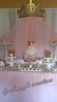 a table topped with lots of cakes and cupcakes on top of a table