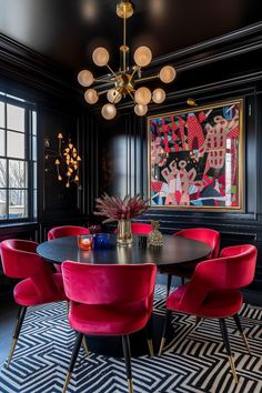 a dining room with black walls and red chairs