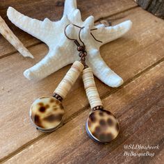 Beach earrings cowrie Shell dangle earrings tropical surfer earrings puka copper brown animal tribal earrings surf fashion jewelry for women Earrings for women. Yes, please. I love to rock a great pair of earrings. Stone, crystal, lampwork, beaded earrings, well I love all of them! Length: 1.5 inches approx. These earrings have 14mm tiger cowrie shells, double sided, 6mm Hawaiian puka shells, copper findings and ear wires. Must haves for beach season, but great for your fall sweaters too! Can't Surfer Earrings, Puka Shell Earrings, Dangle Cowrie Shell Earrings For Beach, Tiger Cowrie Shell, Handmade Shell-shaped Beachy Earrings, Surf Fashion, Bohemian Shell-shaped Earrings For Vacation, Beach Cowrie Shell-shaped Earrings, Earrings Stone