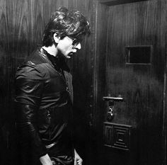 black and white photograph of a man standing in an elevator