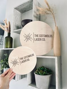 two wooden signs that say the cotswolds laser co