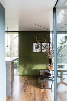 a room with wooden floors and green walls