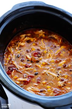 a crock pot filled with chili and corn