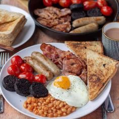 a white plate topped with lots of breakfast foods