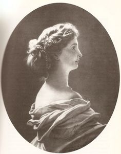 an old black and white photo of a woman with braids in her hair, looking to the side