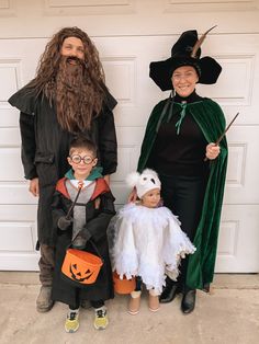 three adults and two children in halloween costumes