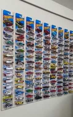 there is a large display of hot wheels on the wall