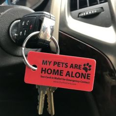 a keychain with a red tag that says, my pets are home alone