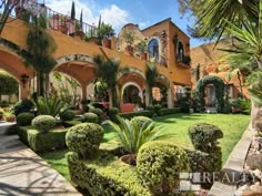 a large house with lots of trees and bushes