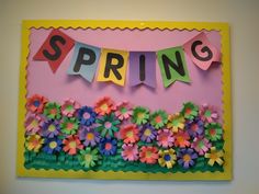 a bulletin board with flowers and the word spring cut out on it's side