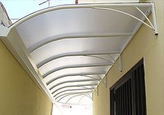 a long white awning on the side of a building