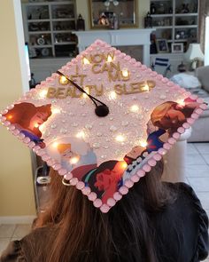 a girl wearing a graduation cap with lights on it's head and the words, no i can beat you sleep