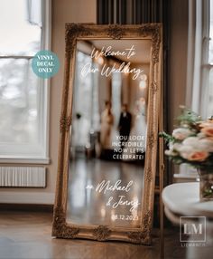 a wedding sign is sitting on the floor in front of a mirror