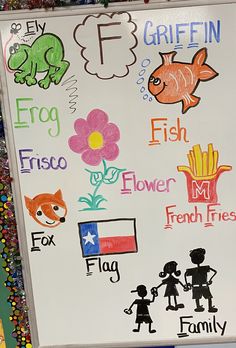 a white board with different types of stickers on it and some children's drawings