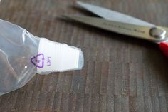 a pair of scissors sitting next to a plastic bag