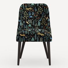 an upholstered chair with forest and animals on it