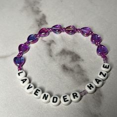 a purple and white beaded bracelet with words that spell out the word awesomeness