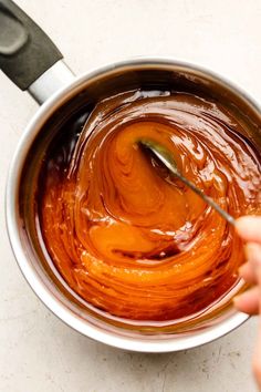 someone is stirring chocolate in a saucepan