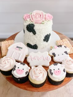 a cake and cupcakes on a wooden table