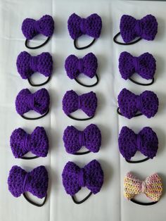 purple crocheted bows and headbands laid out on a table